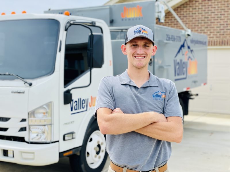 valley junk removal owner standing smiling in front of truck. friendly junk removal services in alabama
