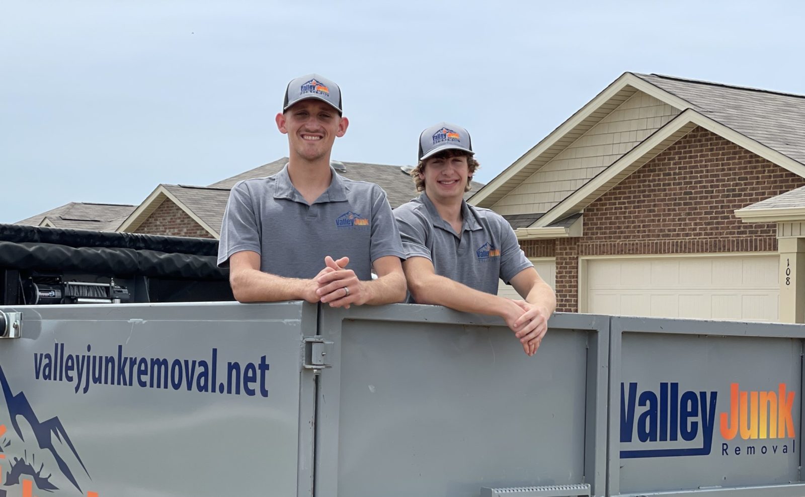 friendly cleanout services with valley junk removal in alabama, two crew members standing in junk removal truck before services