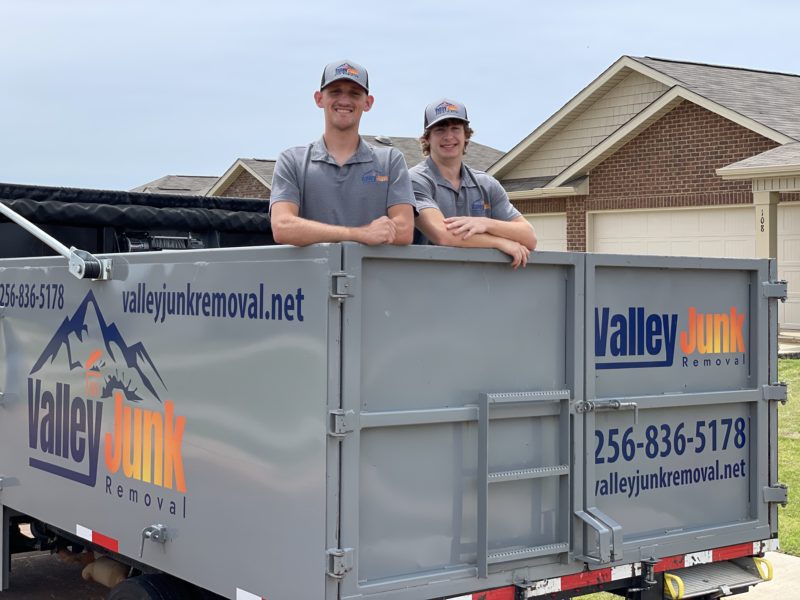 friendly junk removal services with valley junk removal in alabama, two crew members standing in junk removal truck before services