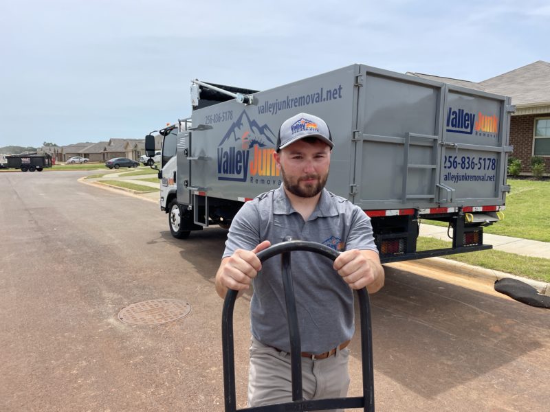 valley junk removal experts standing with equipment from truck for junk removal services