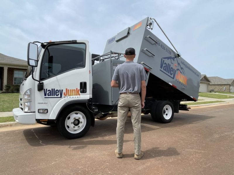 valley junk removal pro in front of junk removal truck