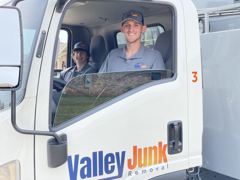 Valley Junk Removal professionals smiling in the truck before providing junk removal services in brownsboro