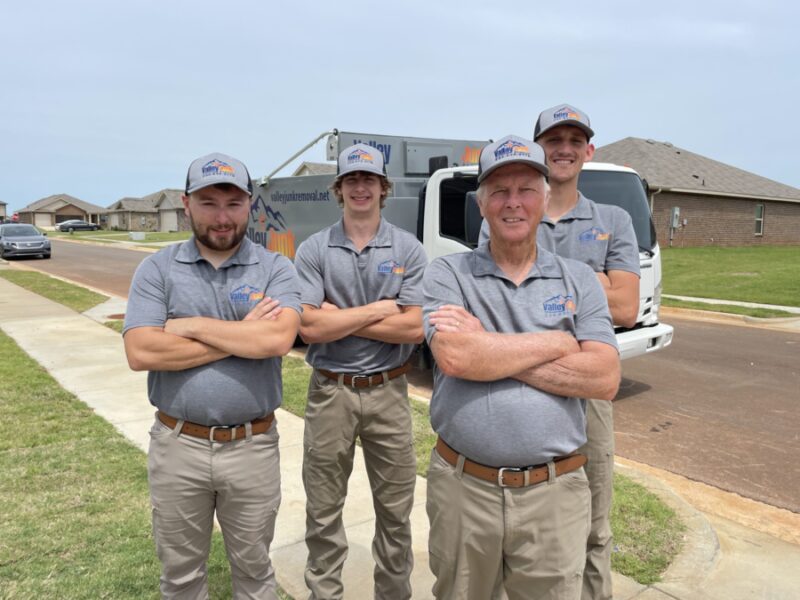 Smiling Valley Junk Removal crew standing proudly in front of their truck