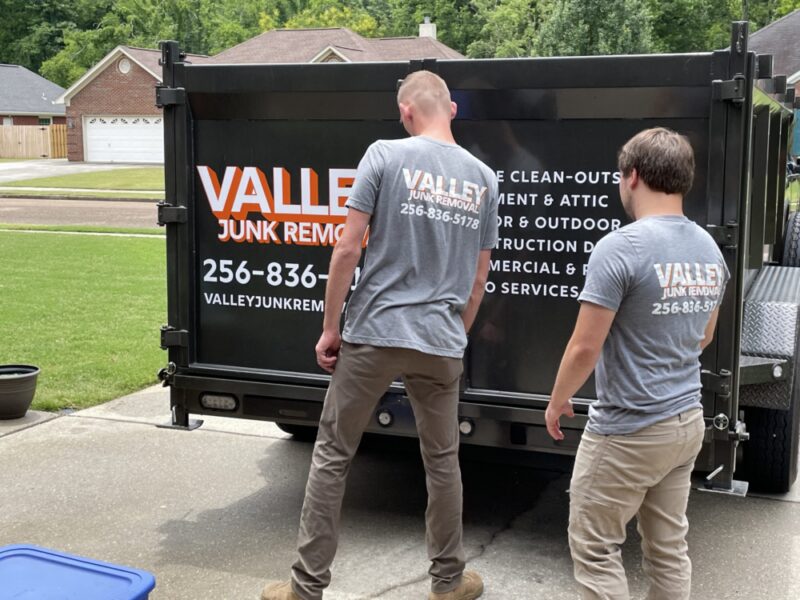 valley junk removal experts hauling junk to a truck